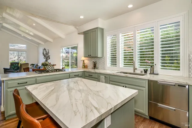 a kitchen with a stove a sink and a refrigerator