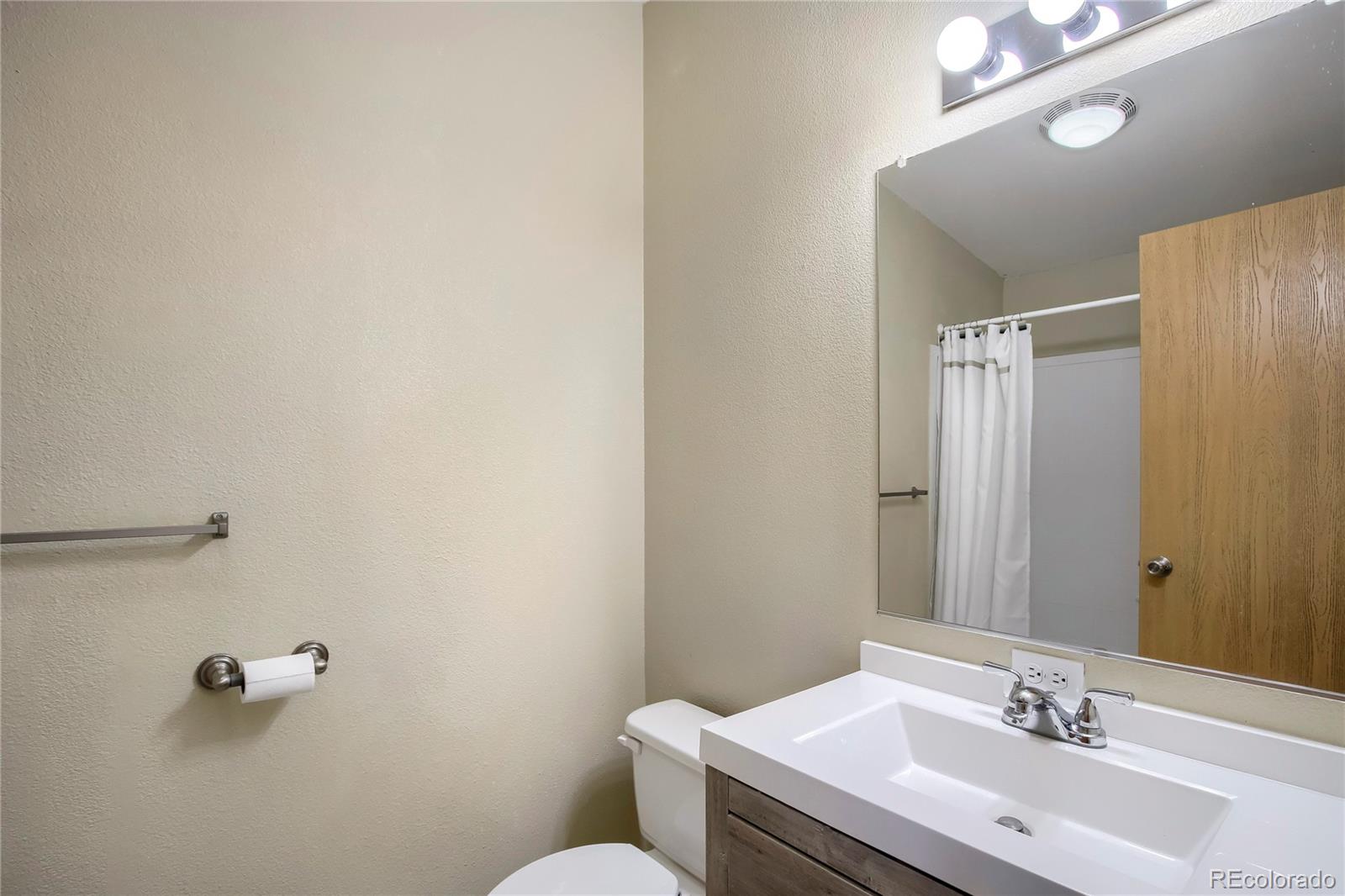 120 Blue Spruce Road Black Hawk, CO 80422 - Photo 19 of 27 a bathroom with a sink and mirror
