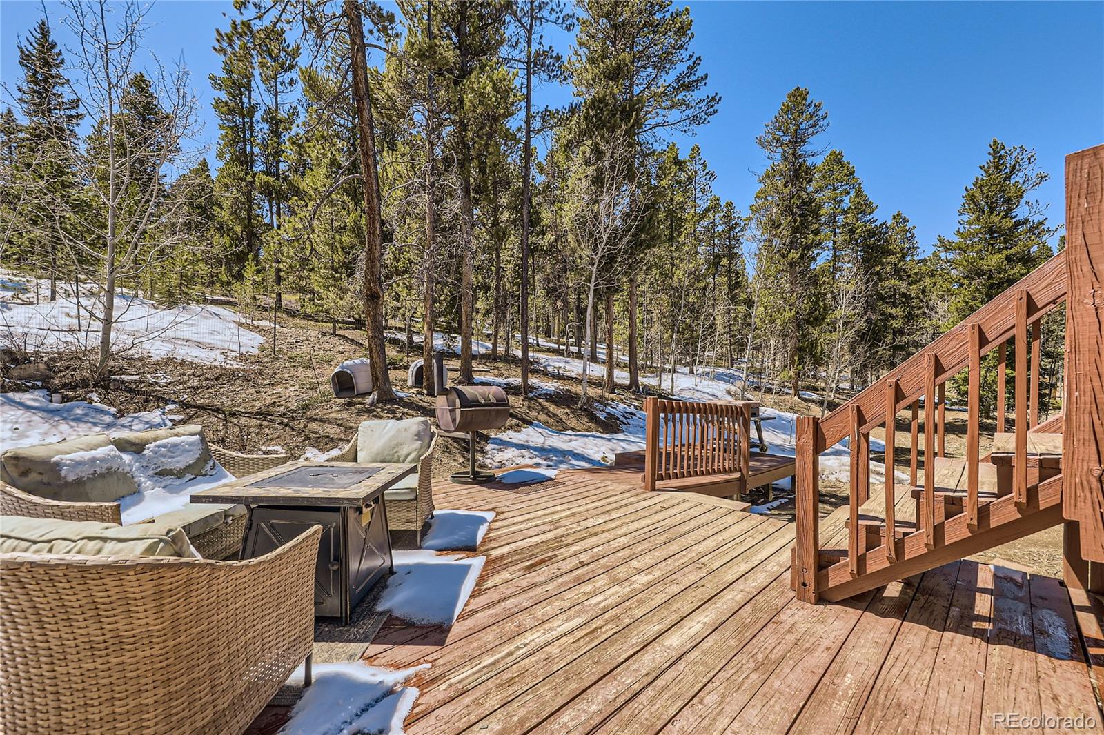 120 Blue Spruce Road Black Hawk, CO 80422 - Photo 25 of 27 a view of a rooftop deck and patio with chairs
