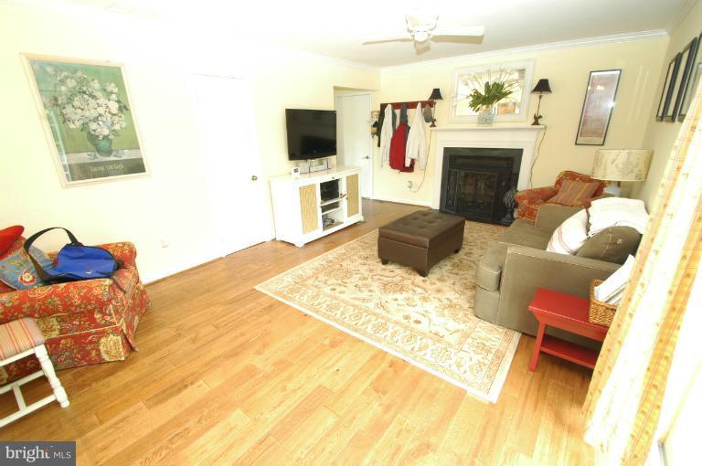 4331 Cub Run Road Chantilly, VA 20151 - Photo 2 of 30 a living room with furniture a flat screen tv and a fireplace