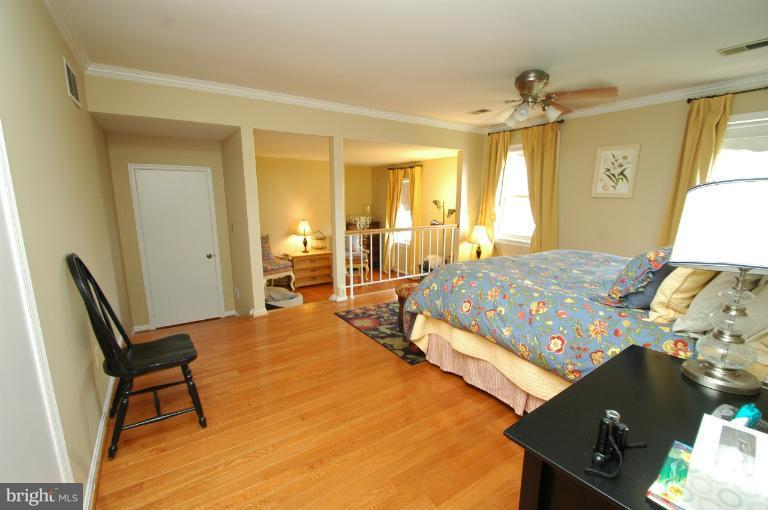 4331 Cub Run Road Chantilly, VA 20151 - Photo 25 of 30 a bedroom with a bed and wooden floor