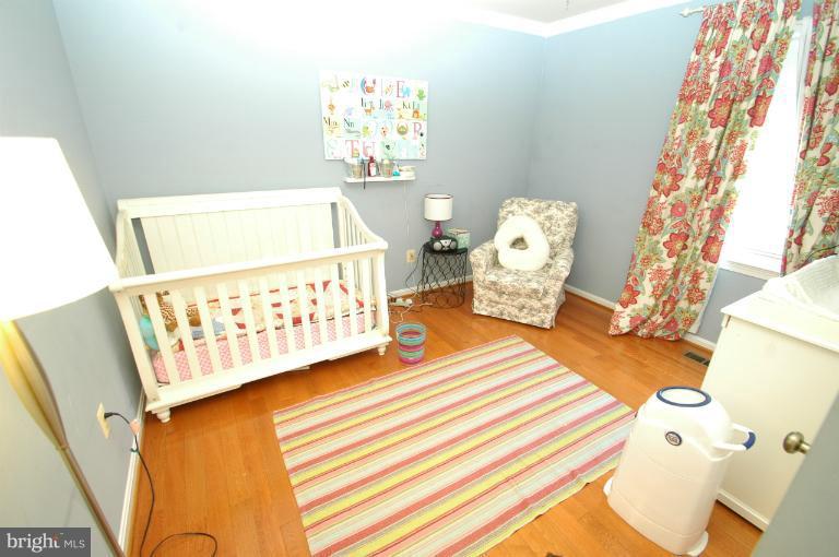4331 Cub Run Road Chantilly, VA 20151 - Photo 10 of 30 a bedroom with a bed and wooden floor