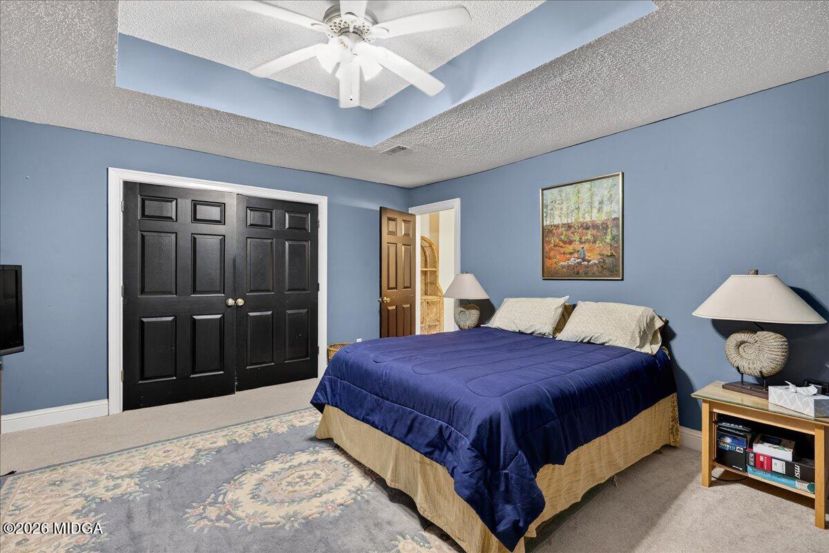 518 River Overlook Forsyth, GA 31029 - Photo 46 of 96 a bedroom with a bed and a chandelier