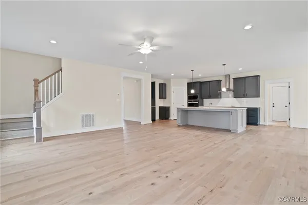 a view of a kitchen with a sink cabinets and wooden floor