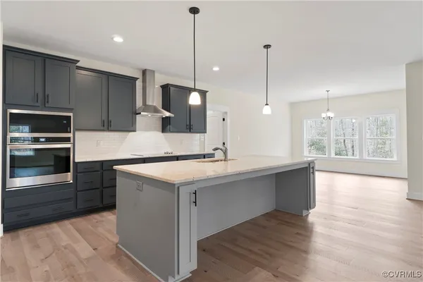 a kitchen with kitchen island a sink stainless steel appliances and cabinets