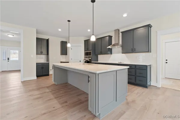 a kitchen with kitchen island a sink stainless steel appliances and cabinets
