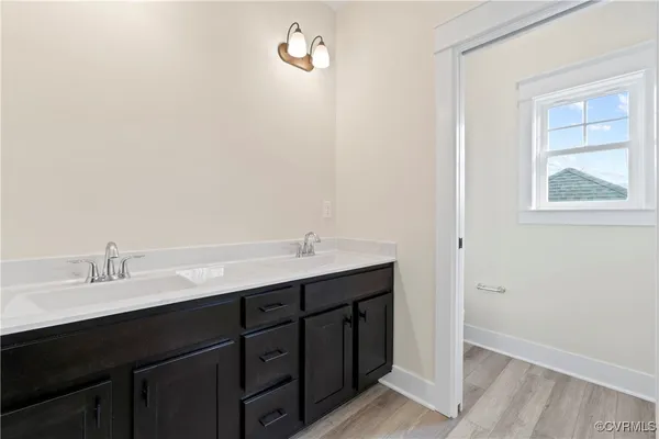 a bathroom with a double vanity sink and mirror