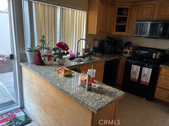 33371 Cheltam Way, Unit 3 Dana Point, CA 92629 - Photo 7 of 24 a kitchen with stainless steel appliances granite countertop a sink stove and cabinets