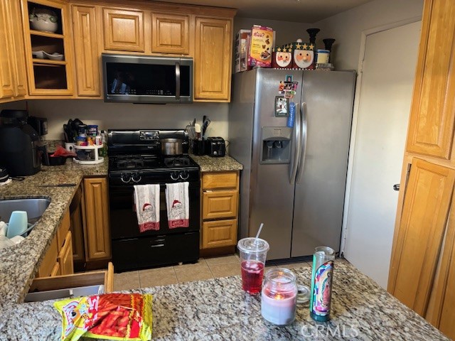 33371 Cheltam Way, Unit 3 Dana Point, CA 92629 - Photo 9 of 24 a kitchen with stainless steel appliances granite countertop a refrigerator sink and stove