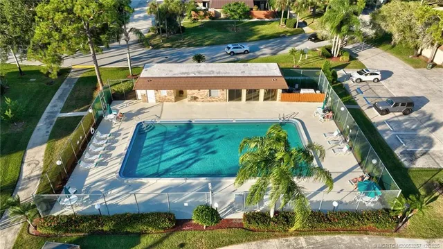 a aerial view of a house with a yard and lake view