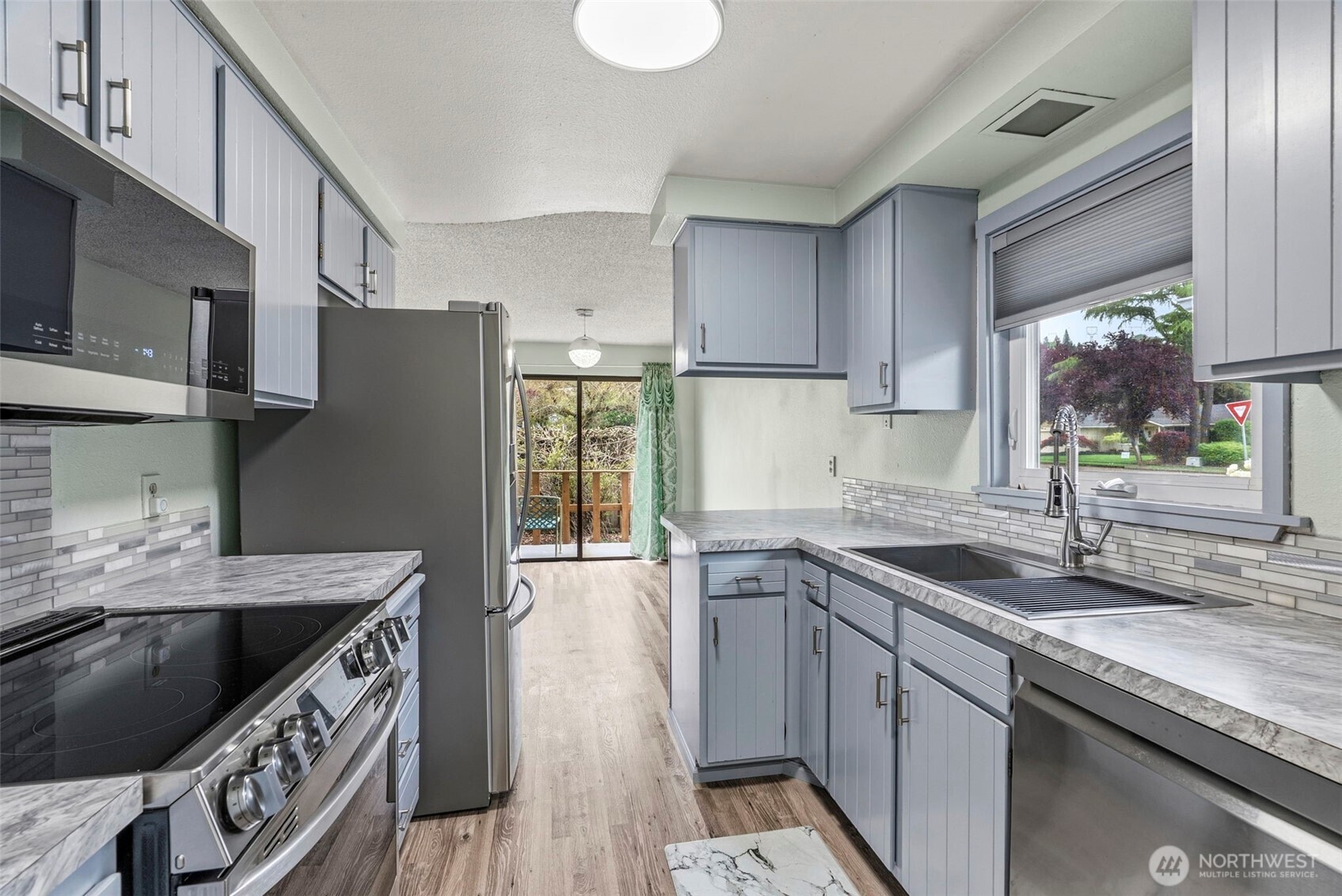 1 Teal Street Longview, WA 98632 - Photo 24 of 36 a kitchen with stainless steel appliances granite countertop a sink stove and refrigerator
