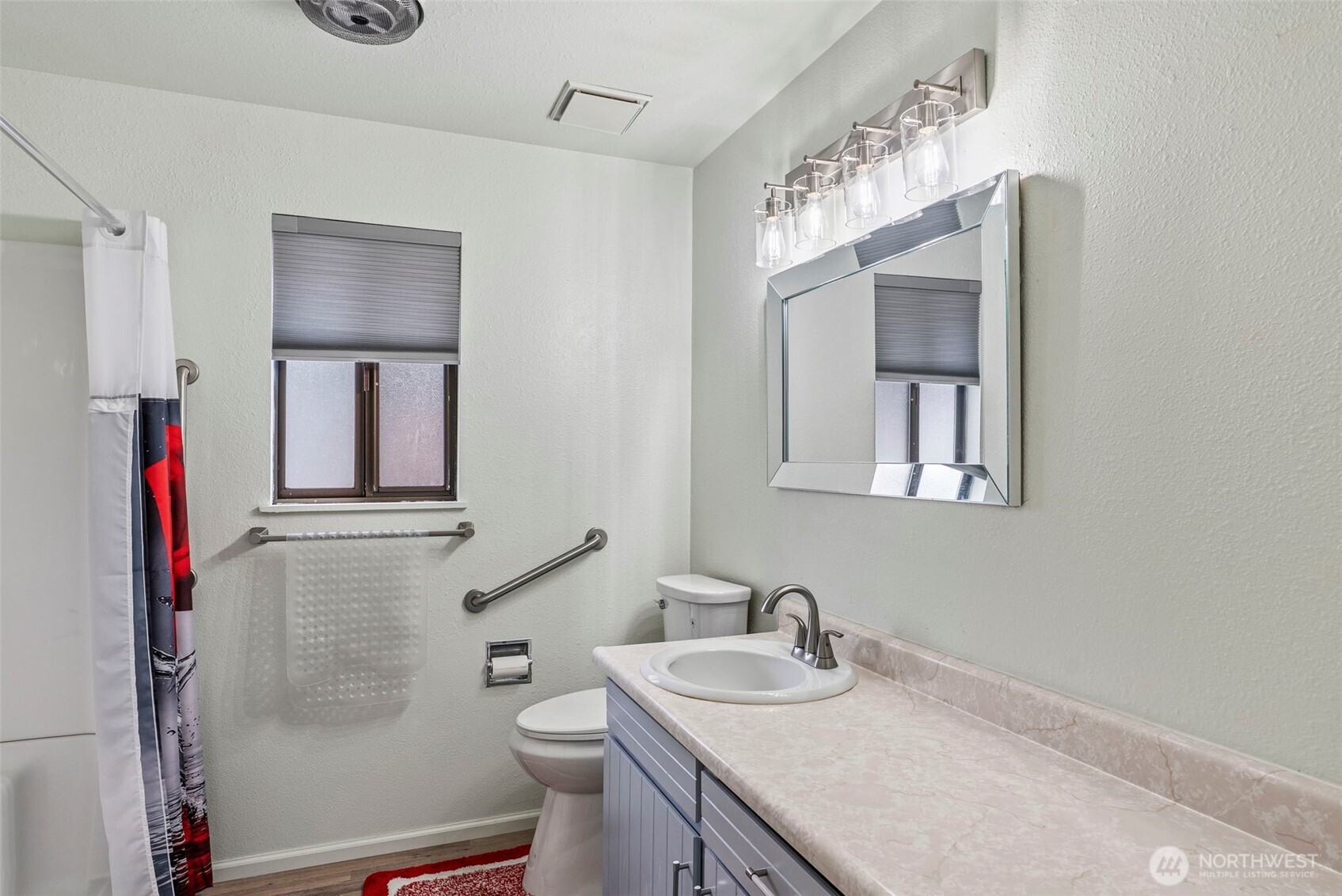 1 Teal Street Longview, WA 98632 - Photo 26 of 36 a bathroom with a granite countertop sink a toilet and mirror