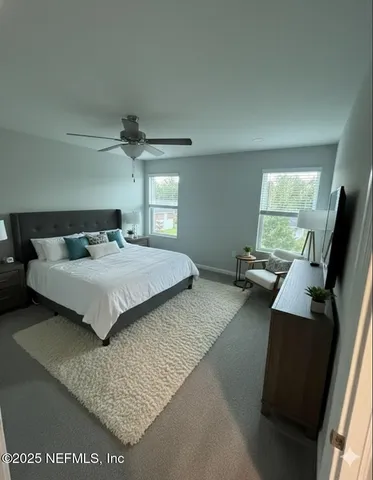 a bedroom with a bed and painting on the wall