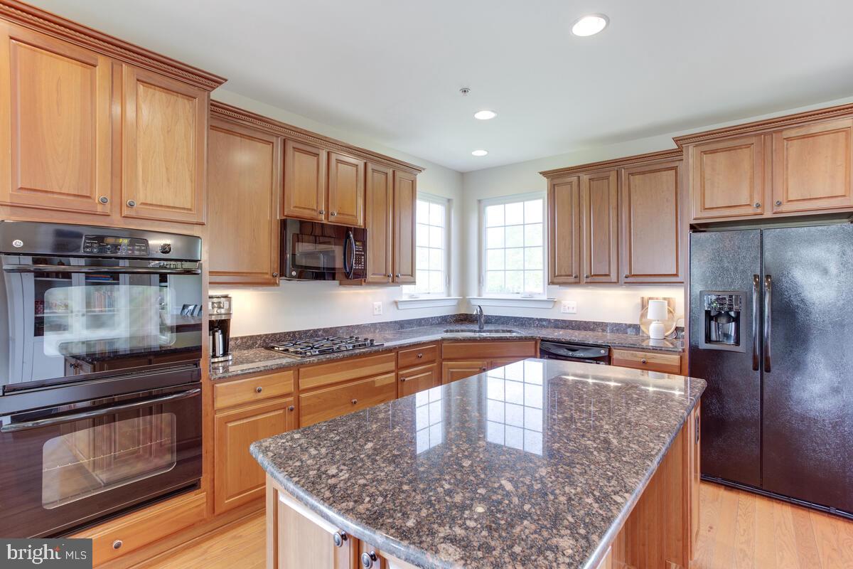378 East Bay Front Road Deale, MD 20751 - Photo 14 of 43 a kitchen with stainless steel appliances granite countertop a sink stove microwave and refrigerator