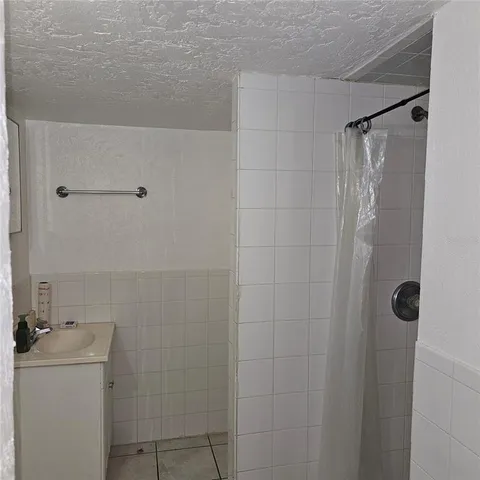 a bathroom with a shower and toilet