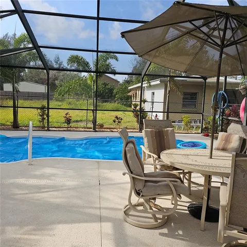 a dining room with furniture and a floor to ceiling window