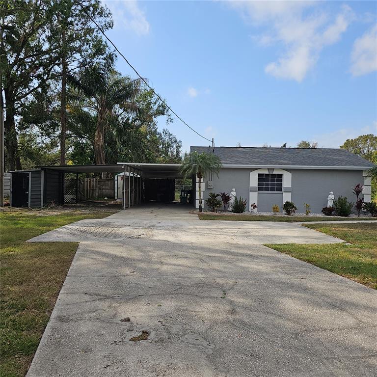 901 8th Street Southwest Ruskin, FL 33570 - Photo 23 of 27 a front view of a house with a yard and a large tree