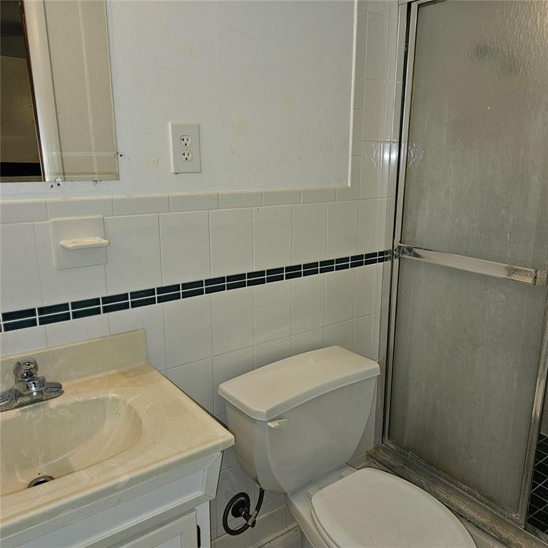 901 8th Street Southwest Ruskin, FL 33570 - Photo 26 of 27 a white toilet sitting next to a bathroom sink