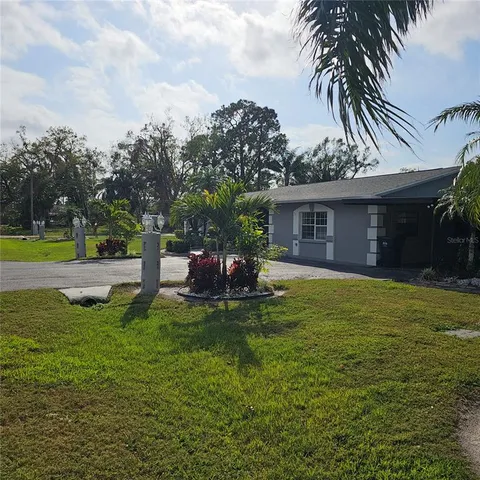 a view of a house with a yard patio and swimming pool