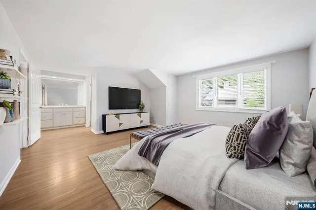 a bedroom with a bed and a television