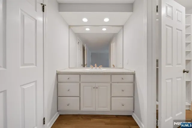 a bathroom with a sink a mirror and a vanity