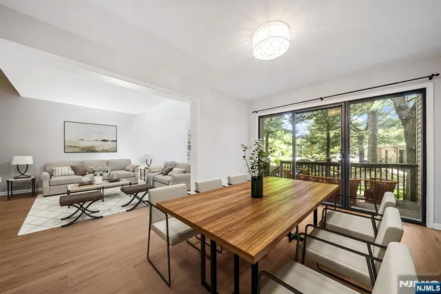 a view of a dining room with furniture wooden floor and a chandelier