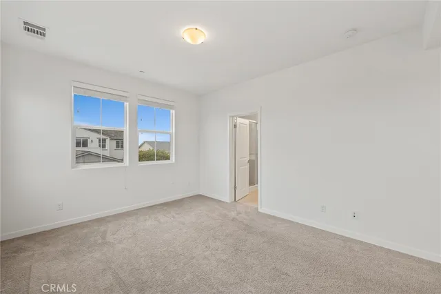 a view of an empty room with closet