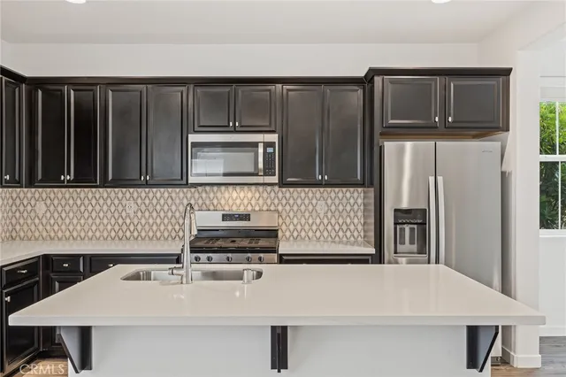 a kitchen with a sink a stove and cabinets