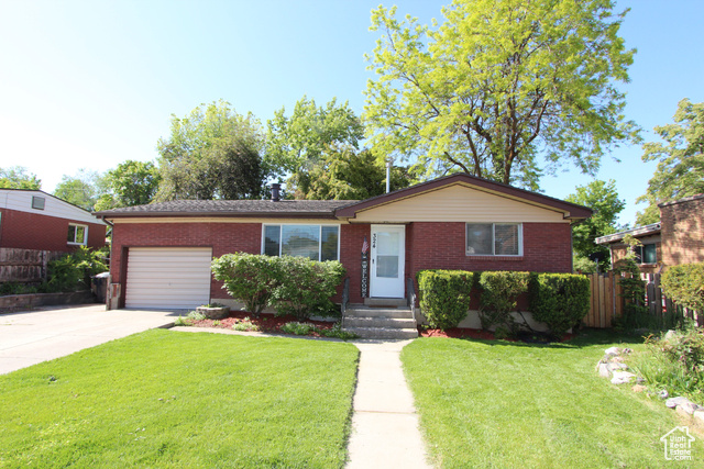 324 West 600 North Logan, UT 84321 - Photo 1 of 1 Single story home featuring an attached garage, brick siding, and driveway