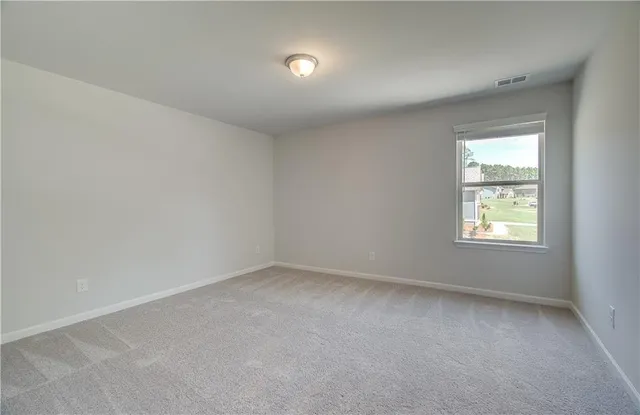 a view of a livingroom with a ceiling fan and window