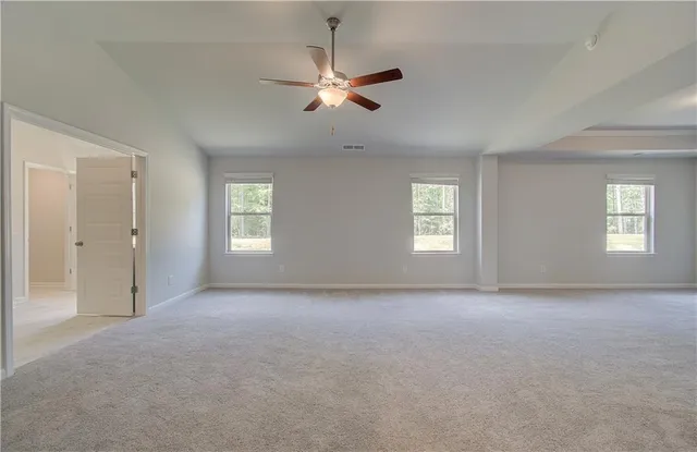 a view of an empty room with a ceiling fan