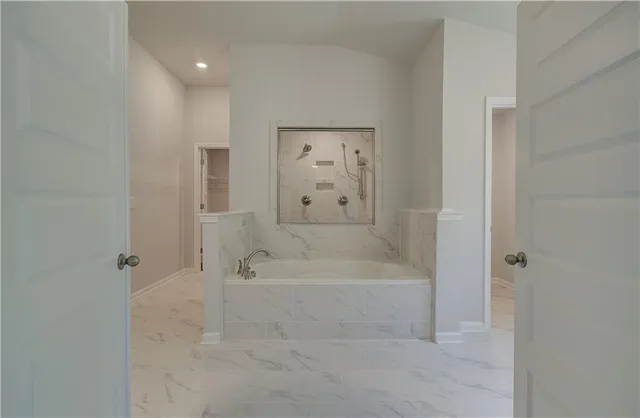 a large bathroom with a double vanity sink mirror and a bathtub