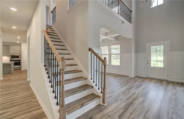 an entryway with wooden floor and stairs