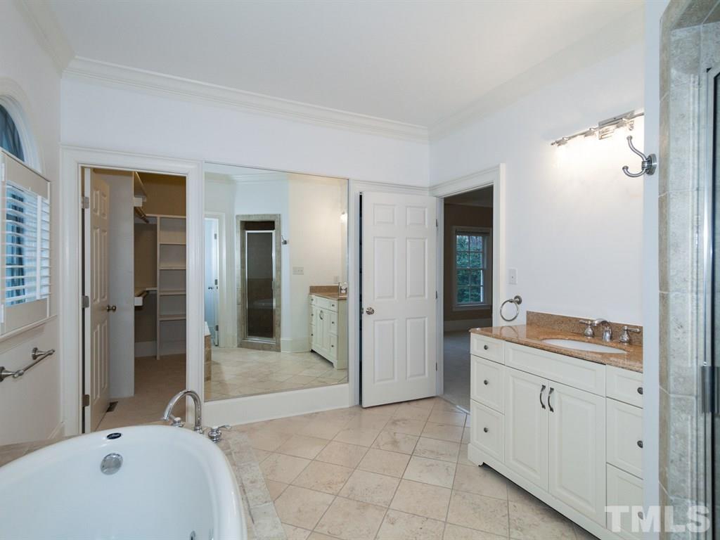 2206 Coley Forest Place Raleigh, NC 27607 - Photo 14 of 25 a spacious bathroom with a tub sink and mirror