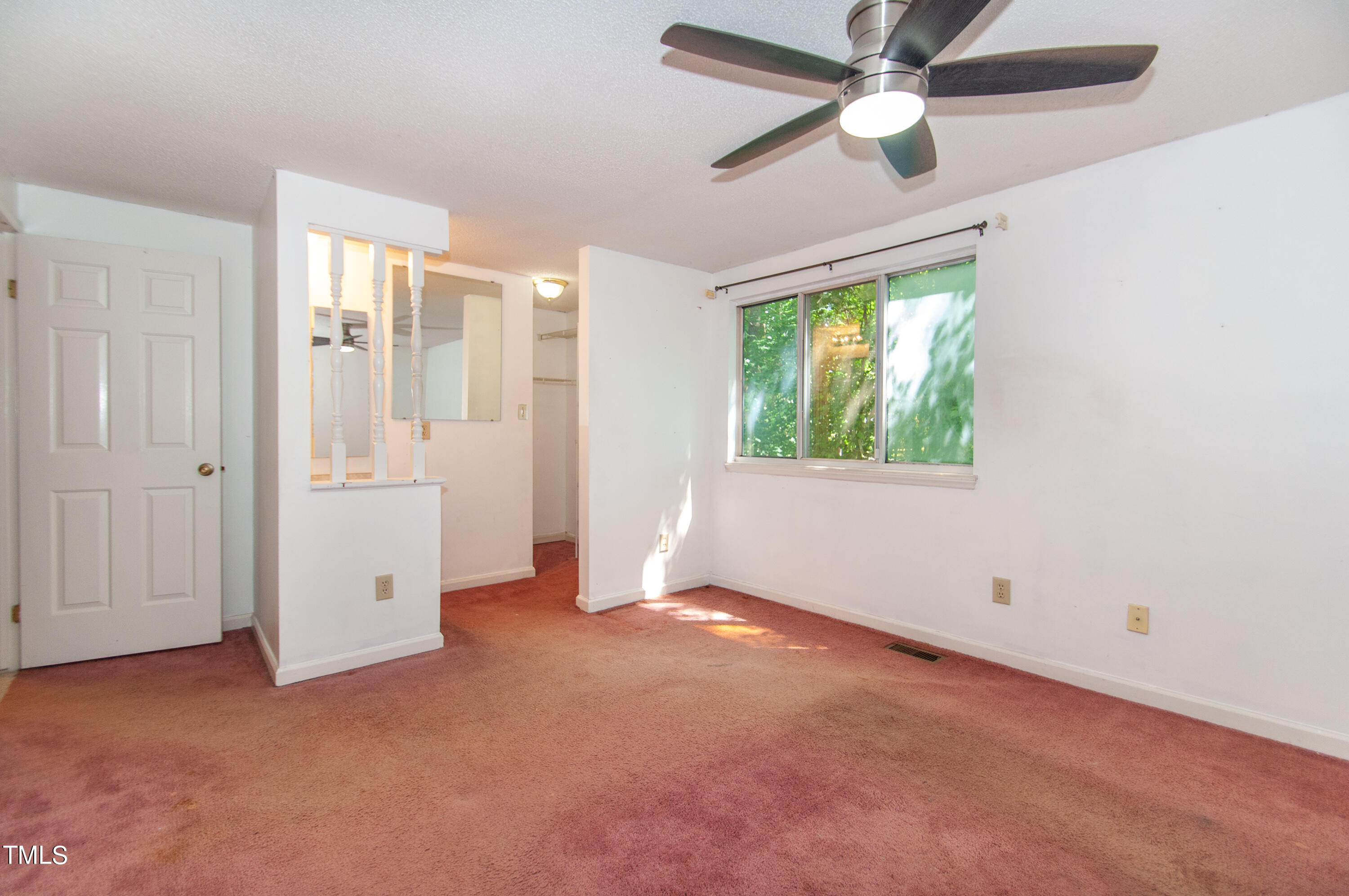 7804 Stephanie Lane Raleigh, NC 27615 - Photo 16 of 37 an empty room with windows and fan