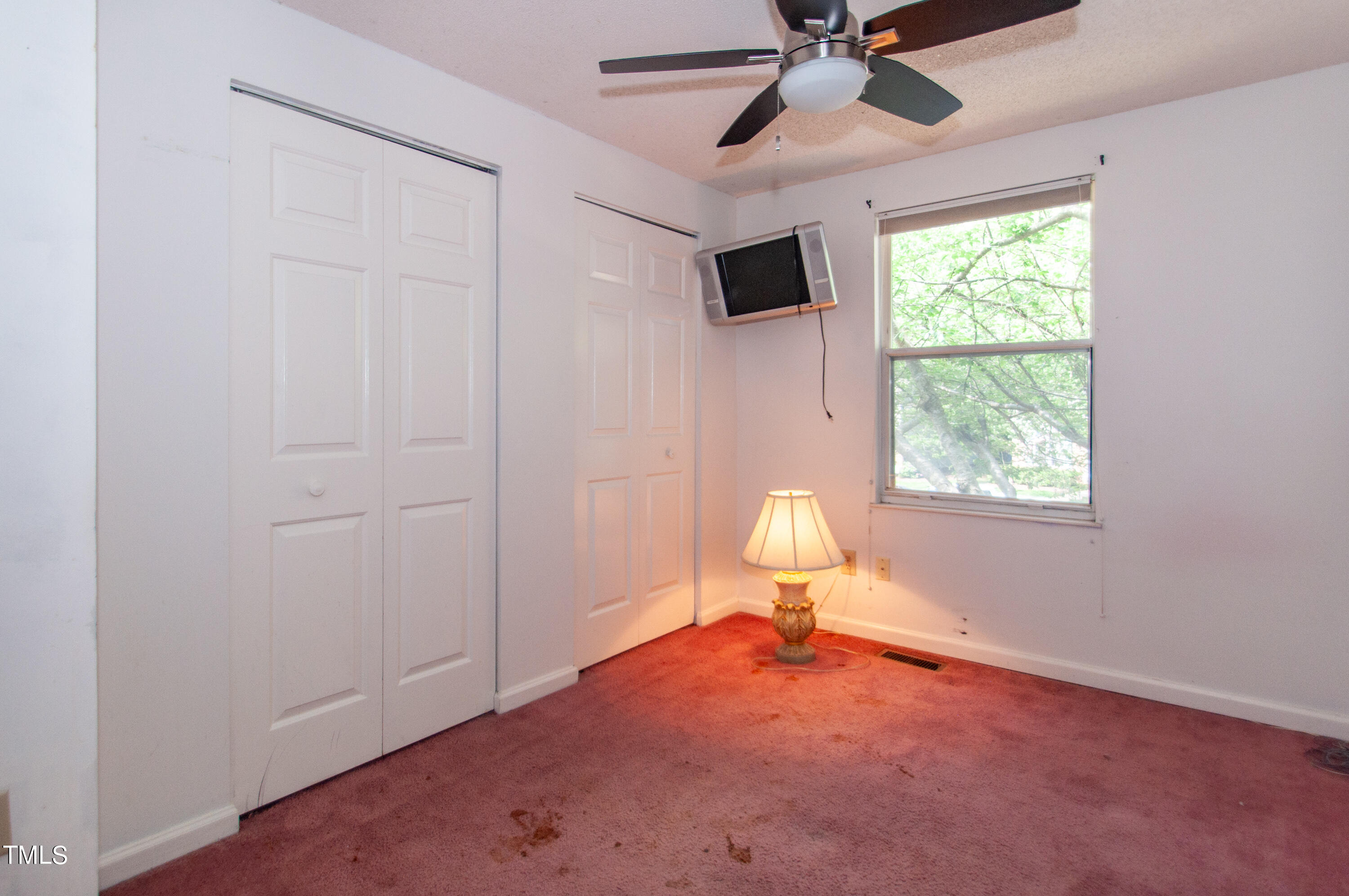 7804 Stephanie Lane Raleigh, NC 27615 - Photo 20 of 37 an empty room with a window and a fan