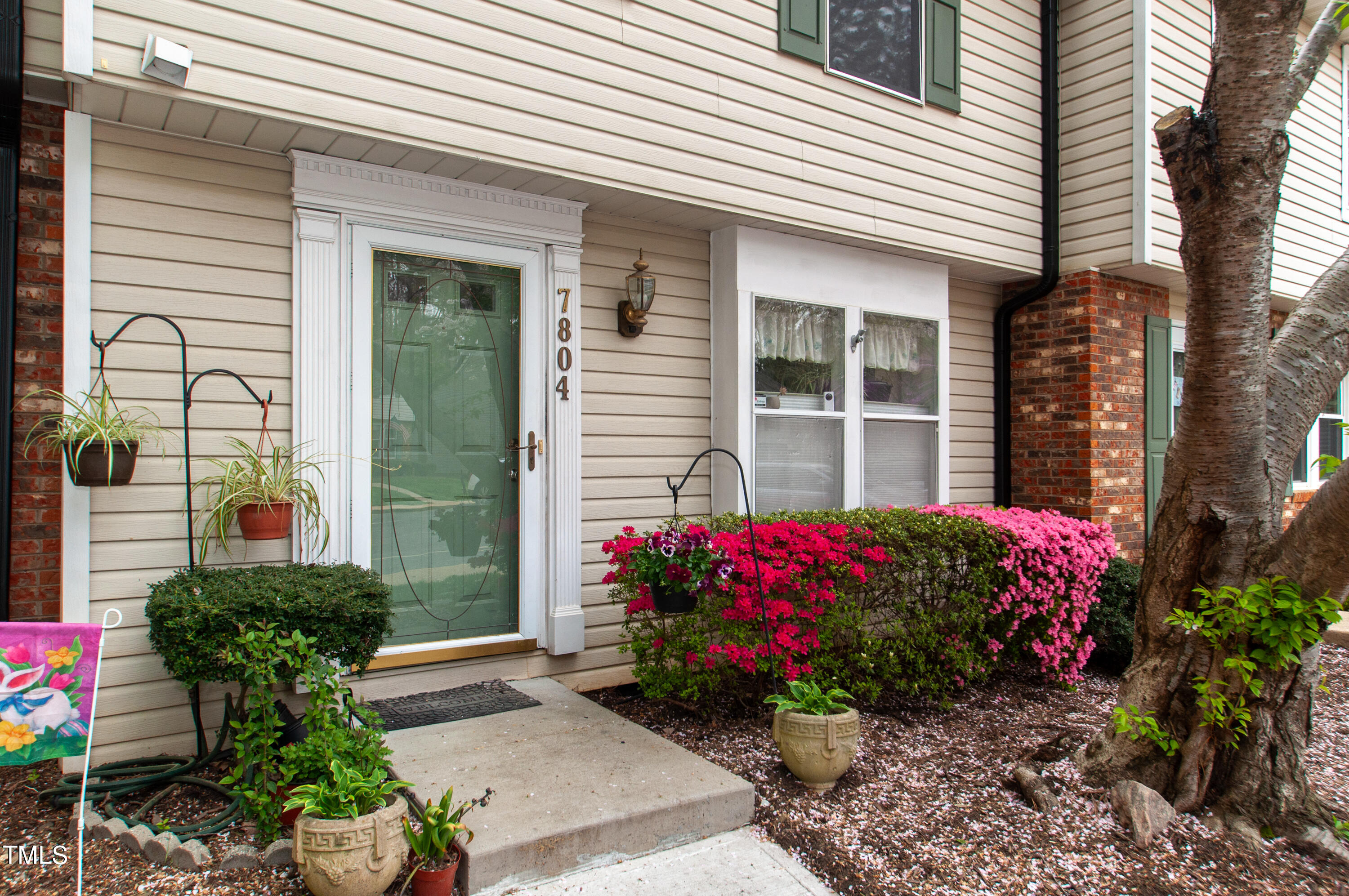 7804 Stephanie Lane Raleigh, NC 27615 - Photo 5 of 37 a view of a potted plant sitting in front of a house