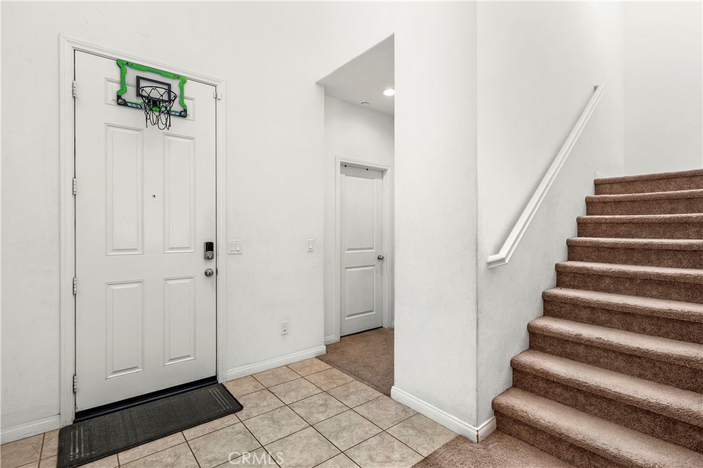 774 Green Court Perris, CA 92571 - Photo 18 of 25 a view of a hallway with wooden floor and entryway
