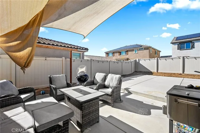 a patio with a table and chairs