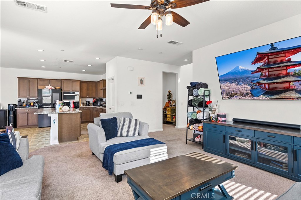 774 Green Court Perris, CA 92571 - Photo 2 of 25 a living room with furniture and kitchen view