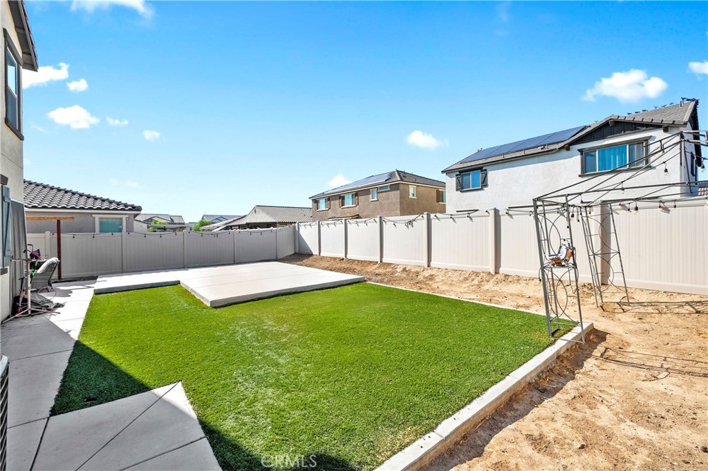 774 Green Court Perris, CA 92571 - Photo 22 of 25 a view of a backyard with plants and a patio
