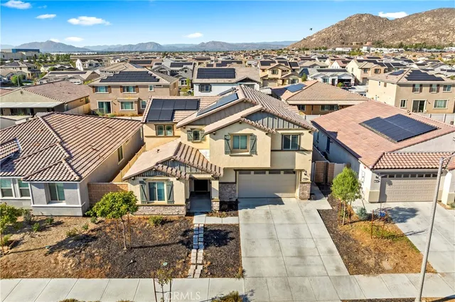 a view of a white building among the street and tall buildings