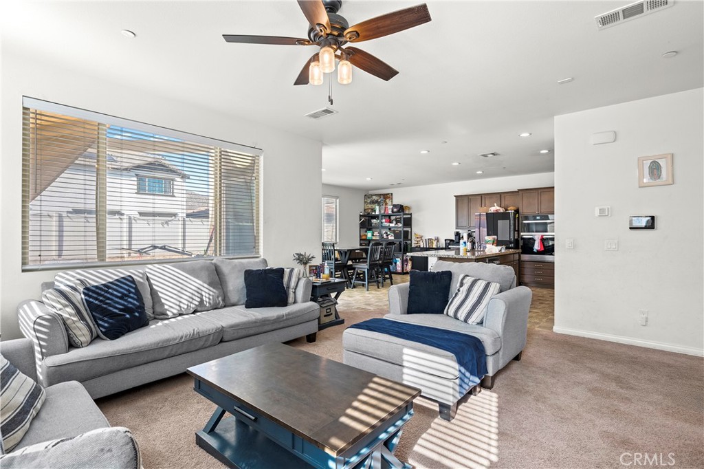 774 Green Court Perris, CA 92571 - Photo 4 of 25 a living room with furniture and a large window