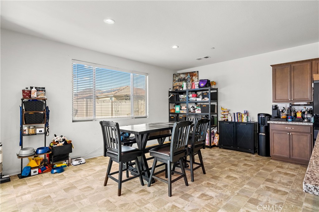 774 Green Court Perris, CA 92571 - Photo 6 of 25 a view of a dining room with furniture and a window