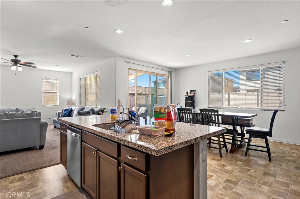 774 Green Court Perris, CA 92571 - Photo 7 of 25 a kitchen with sink cabinets and dining table