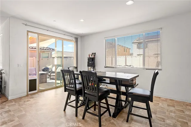 a view of a dining room with furniture and a window