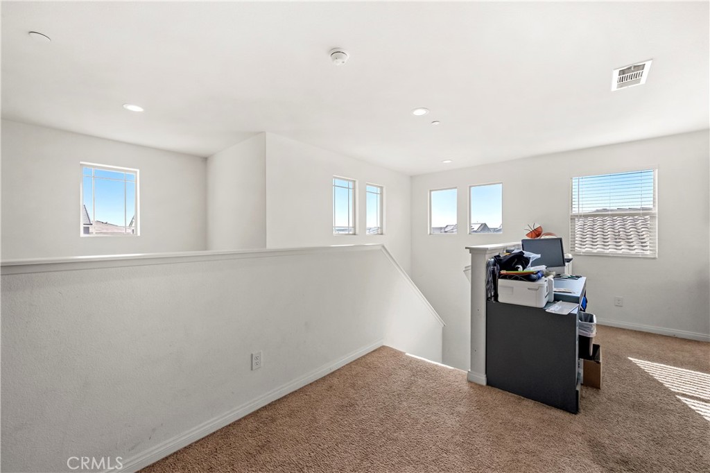 774 Green Court Perris, CA 92571 - Photo 9 of 25 an empty room with furniture and windows