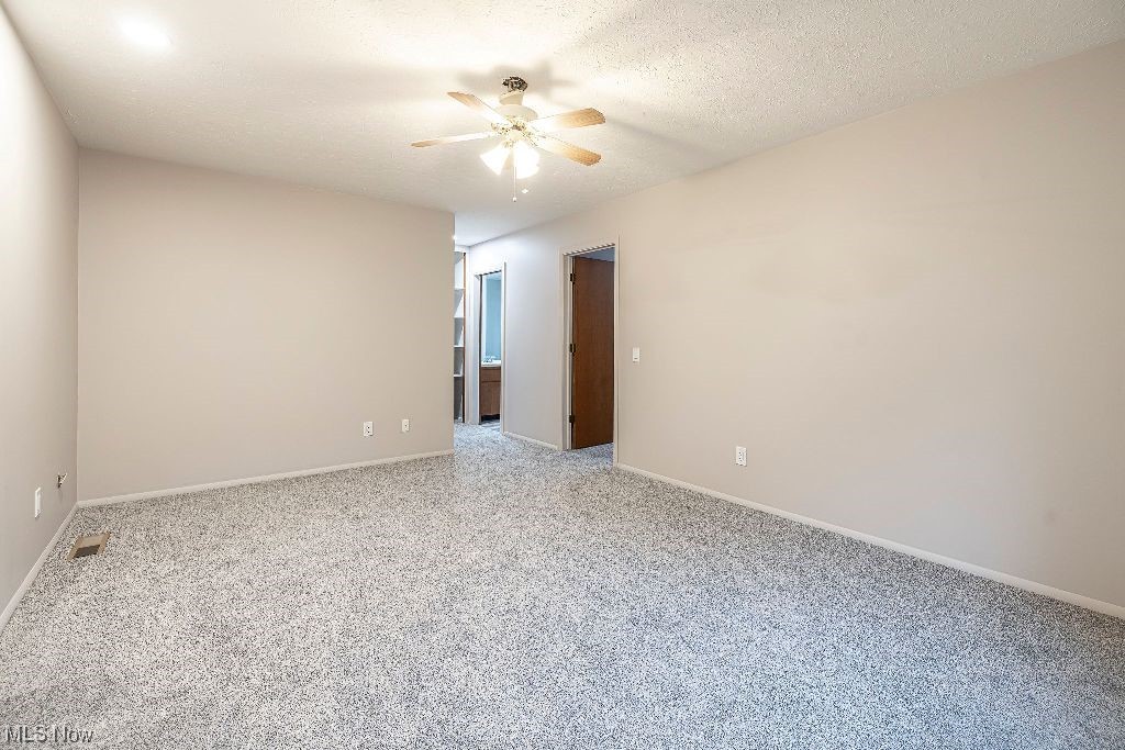 10808 Priem Road Strongsville, OH 44149 - Photo 11 of 26 Unfurnished room featuring light colored carpet, ceiling fan, and a textured ceiling
