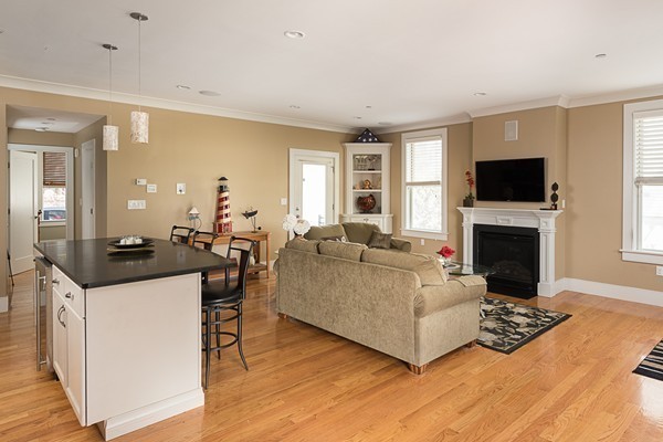 1506 Columbia Road, Unit 1 Boston, MA 02127 - Photo 11 of 24 a living room with furniture a flat screen tv and a fireplace