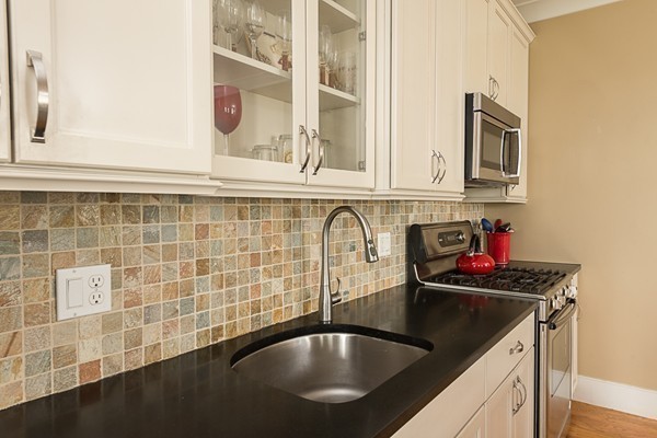 1506 Columbia Road, Unit 1 Boston, MA 02127 - Photo 12 of 24 a kitchen with a sink and cabinets